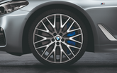 Close-up of a BMW car wheel with a gray background